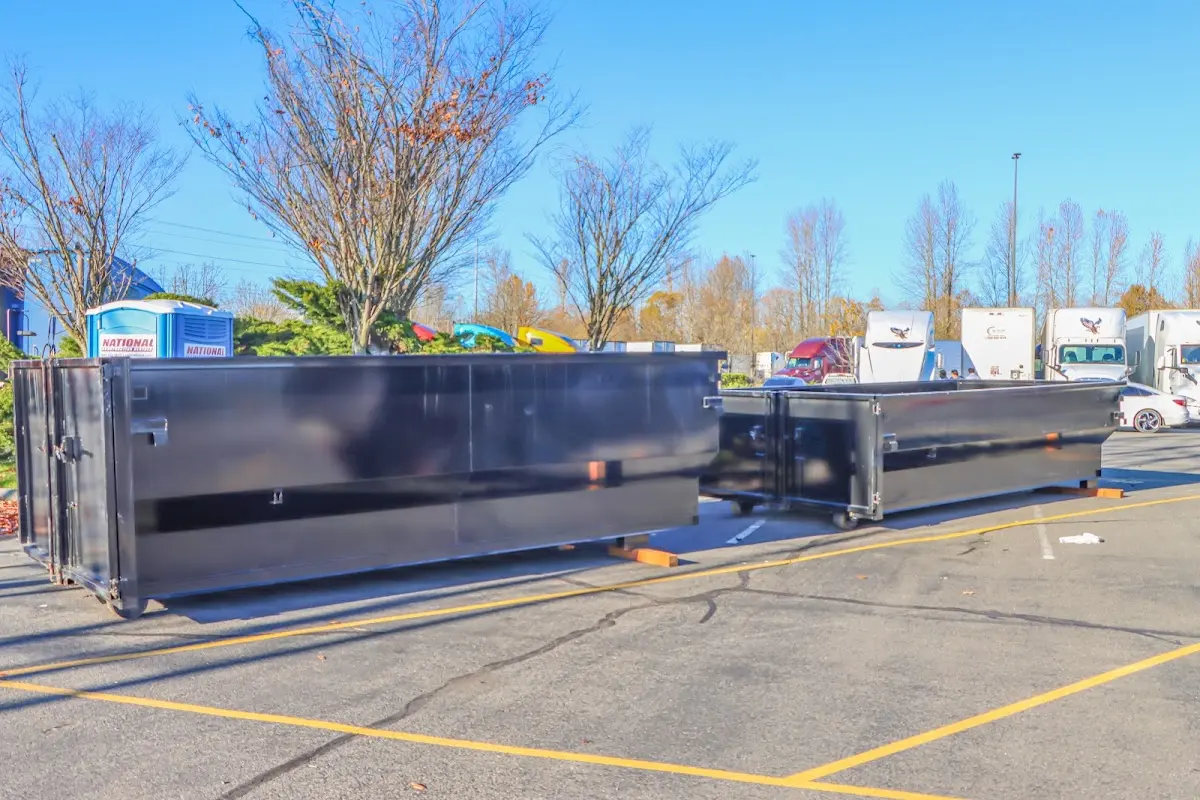 Professional dumpster rental service with roll-off container on residential driveway in Oregon